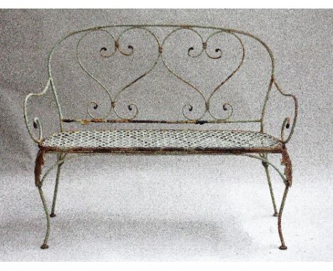 A 20th century painted cast iron garden bench, the scrolling back with two heart shaped supports, with mesh seat, raised on c