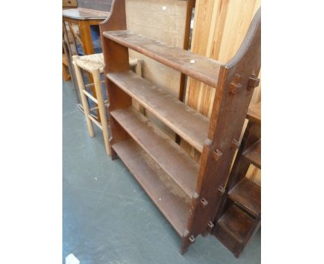 An oak four graduating book shelf with peg supports 86cmW