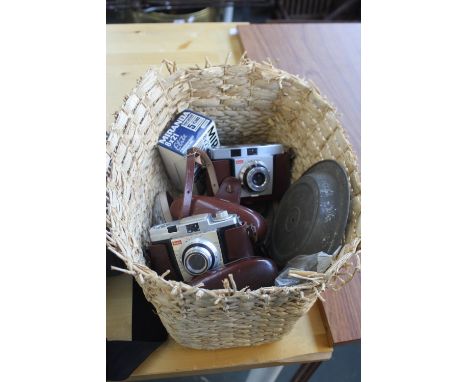 A basket containing a Kodak Colorsnap 35 35mm camera in case; a Koak Colorsnap 35 Model 2 35mm camera in case; a boxed pair o