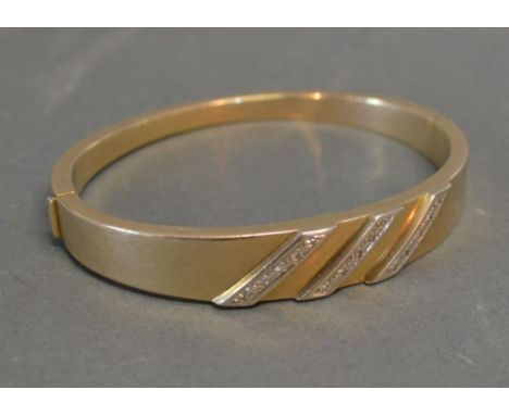 A 9ct. Gold Bangle  set with three rows of Diamonds, 16 gms 