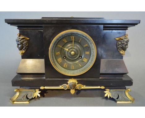 A Victorian Black Slate and Gilt Metal Mounted Mantle Clock, the dial with Roman numerals and two train movement, the case mo