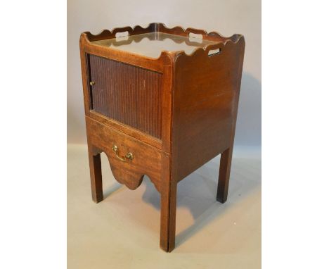A George III Mahogany Nightstand with a shaped galleried top above a tambour and pullout commode with brass handle, raised up