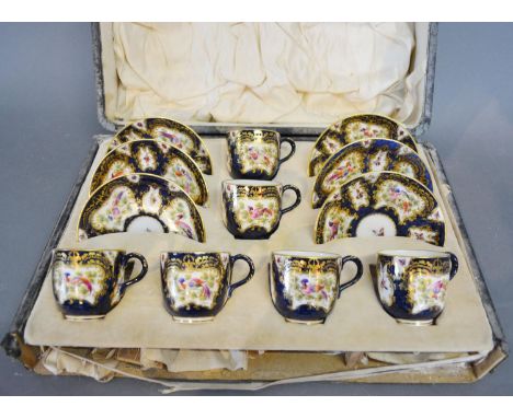 A Royal Worcester Porcelain Coffee Service, hand painted with exotic birds and butterflies amongst foliage upon a dark blue g