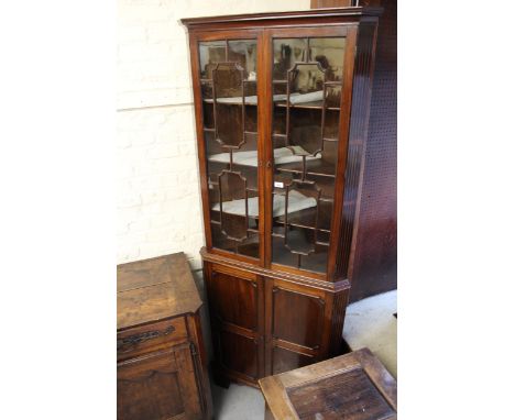 19th Century mahogany floor standing corner cabinet, with moulded cornice above pair of astragal glazed doors, with two panel