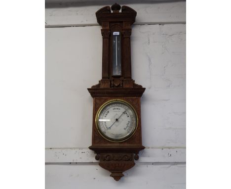 Late 19th / early 20th Century carved oak aneroid barometer thermometer by Negretti & Zambra, in architectural form case (the