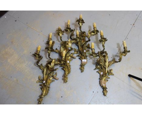 Set of four good quality ormolu rococo design three light wall sconces , each approximately 22ins high 