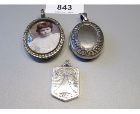 Victorian white metal oval locket, another later silver locket and a 19th Century portrait pendant set paste 