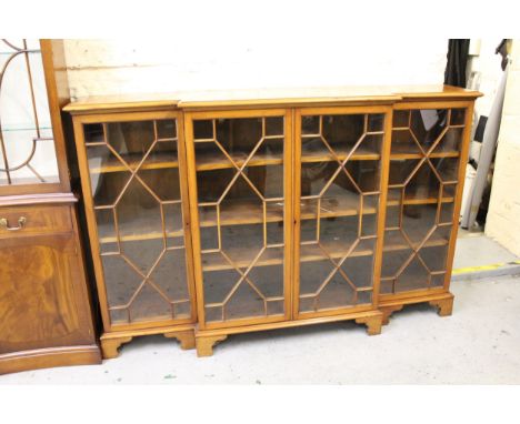 Late 19th / early 20th Century mahogany dwarf breakfront bookcase, the moulded top above four astragal glazed doors enclosing