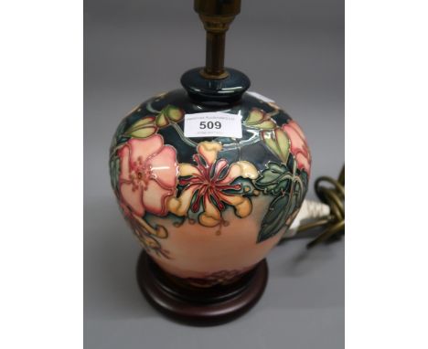 Modern Moorcroft oviform table lamp decorated in the Honeysuckle pattern, 6.75ins high excluding the wooden base and brass fi