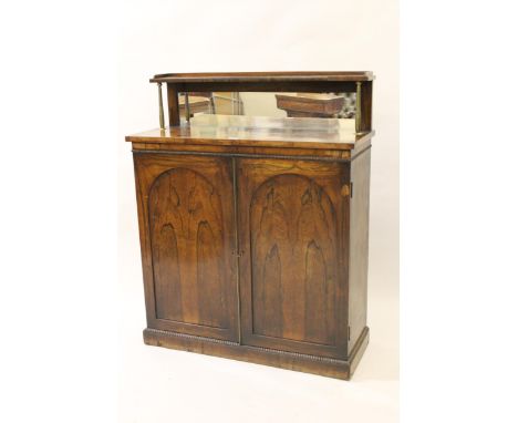 Small regency rosewood chiffonier, the shelved and mirrored back, supported by brass baluster uprights above a plain frieze, 