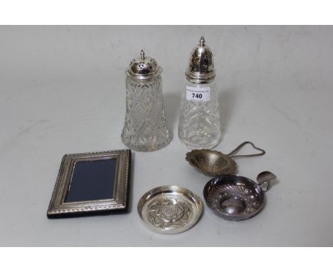 Two silver mounted cut glass sugar casters, small silver mounted photograph frame, silver tea strainer, small silver Tudor ro