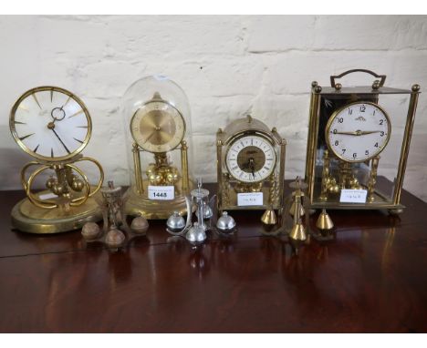 Small brass anniversary clock under glass dome, another by the same maker, lacking dome, two brass and glass cased mantel clo
