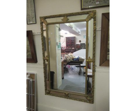 19th Century rectangular gilded composition cushion framed wall mirror, with sectional plate border, 58ins x 37ins (some dama