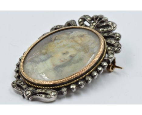 19th Century brooch inset with an oval portrait miniature of a lady, with pierced surmount 