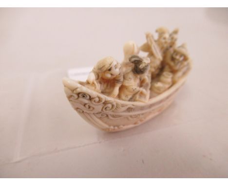 Japanese Meiji period carved ivory Netsuke, in the form of figures in an open boat, 2.25ins wide 