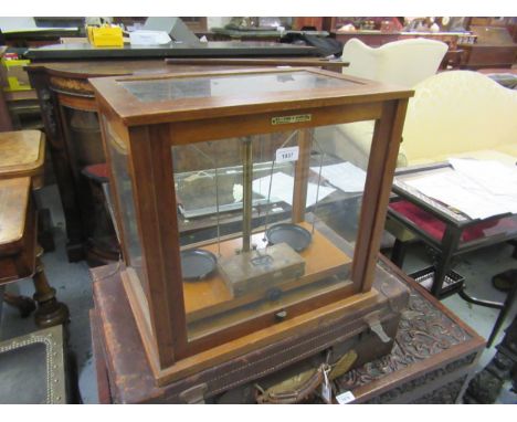 Pair of laboratory balance scales by W & J George & Becca Limited, London, in a four glass case, 17.75ins wide, together with