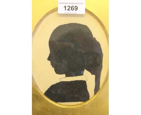 19th Century oval mounted silhouette portrait of a girl, in gilt and ebonised frame, 5.5ins x 4.25ins 