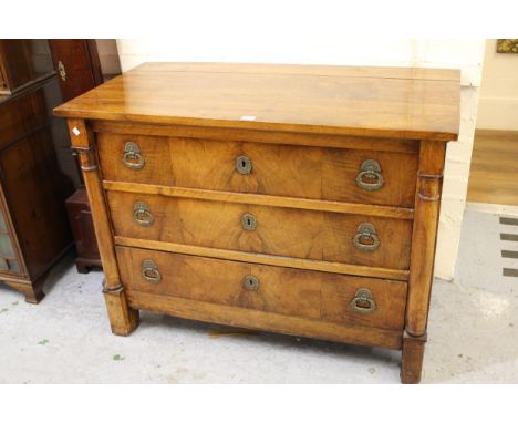 Early 19th Century French walnut commode, the plain top above three graduated drawers with original brass handles and escutch