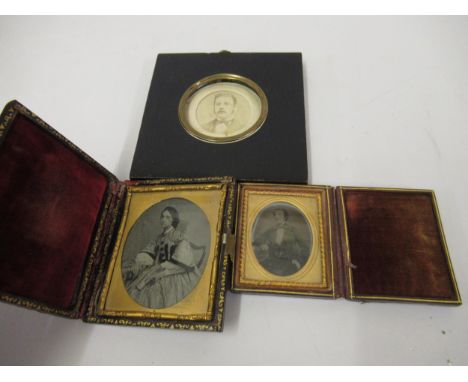 Two leather cased Ambrotypes and a circular mounted portrait 