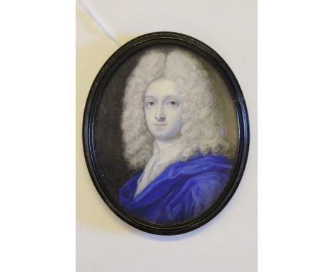 Attributed to Benjamin Arlaud, watercolour portrait miniature of a young man wearing a blue coat, 80mm x 65mm approximately, 