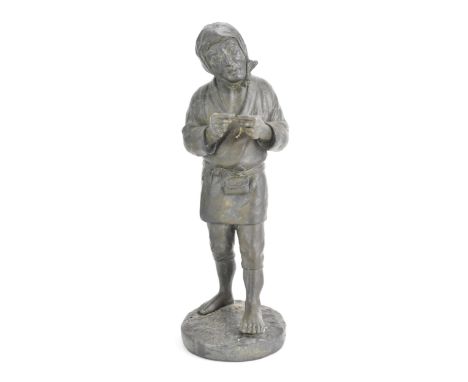 A Japanese Meiji period cast iron figure depicting a gent holding a pipe and standing on a naturalistic base, seal mark to th