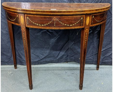 A George III mahogany and satinwood crossbanded marquetry inlaid demi-lune fold-over card table, in the Sheraton taste, c.179