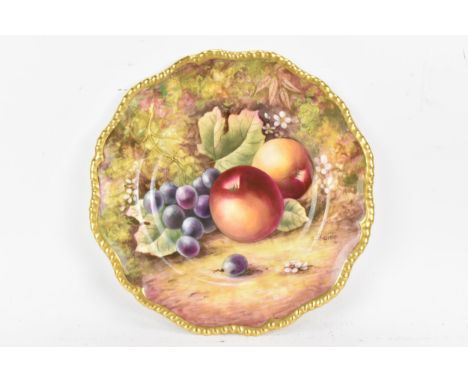 A Royal Worcester fruit decorated cabinet plate, of shaped circular form, hand painted with still lives of fruit and signed J