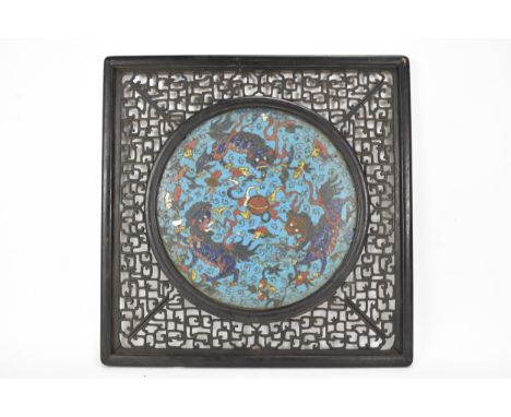 A 19th Chinese cloisonne panel and mirror, housed in an ebonised pierced frame with, the panel having a mercury mirror to one
