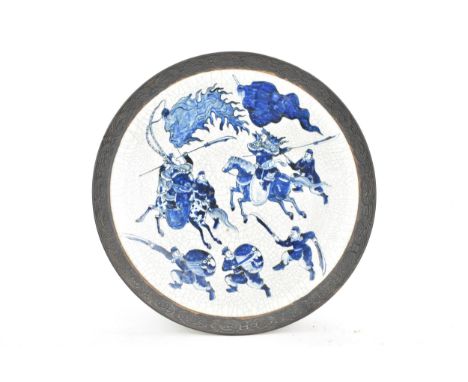 A Chinese nanking blue and white crackle glazed charger, Qing dynasty, late 19th century, decorated with warriors, oxidised r