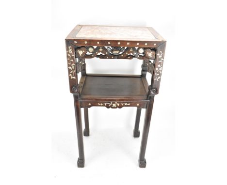 A Chinese late Qing dynasty padouk wood two tier table, having a rectangular top inset with marble, pierced carved fretwork, 