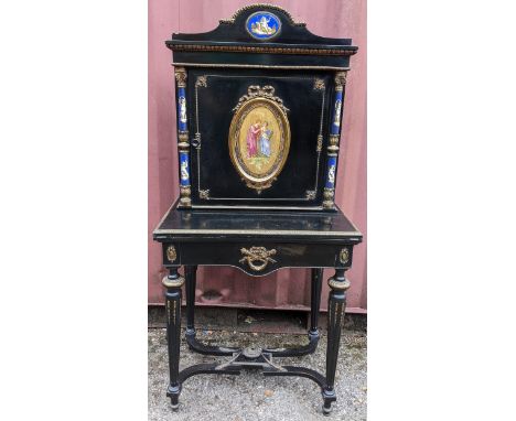 A Napoleon III ebonised and ormolu mounted lady"s bonheur du jour, 19th Century, shaped cresting above a door mounted with an