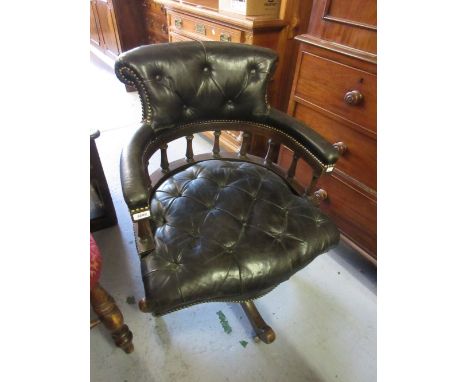 Reproduction mahogany and button leather upholstered swivel office chair on a quadruped base