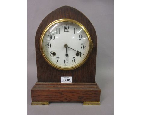 Oak cased lancet shaped two train mantel clock with enamel dial together with two black slate mantel clocks
