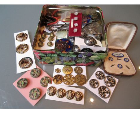 Tin containing a collection of enamel, Chinese and other buttons