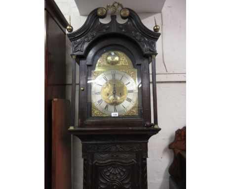 Antique oak longcase clock having all-over later carved decoration, the brass arch top dial with silvered chapter ring, secon