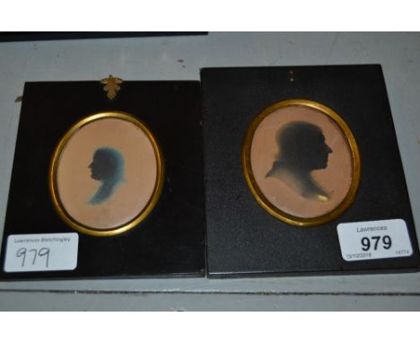 Two 19th Century oval silhouette portrait pictures of gentlemen housed in rectangular papier mache frames
