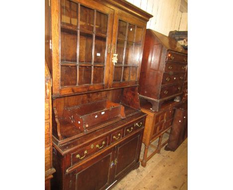 Good quality reproduction oak dresser in George III style, the moulded cornice above a pair of reeded bar glazed doors enclos