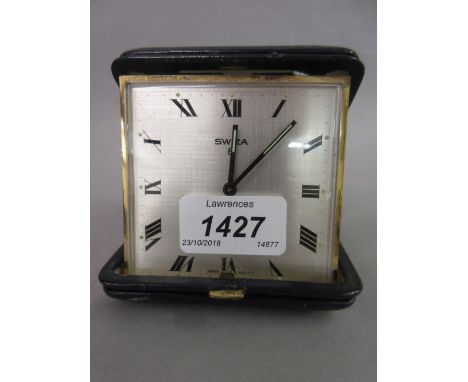 Swiss blue leather cased travelling alarm clock, the silvered dial with Roman numerals