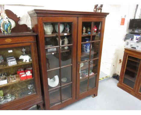 George III mahogany bookcase top, the moulded cornice above a pair of bar glazed doors enclosing adjustable shelves on later 