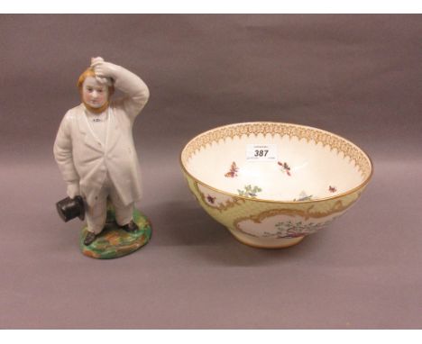 Continental porcelain figure of a man holding a top hat, together with a modern Worcester bowl CONDITION REPORT Crazing has f