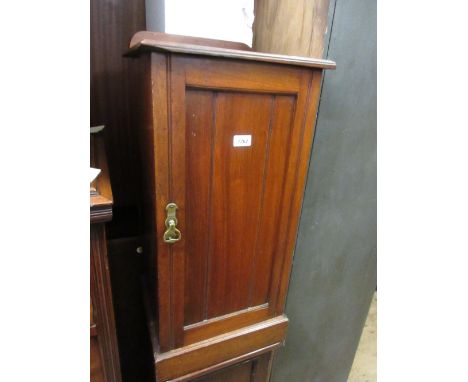 Late 19th Century walnut single door pot cupboard together with an early 20th Century cane back commode chair on turned reede