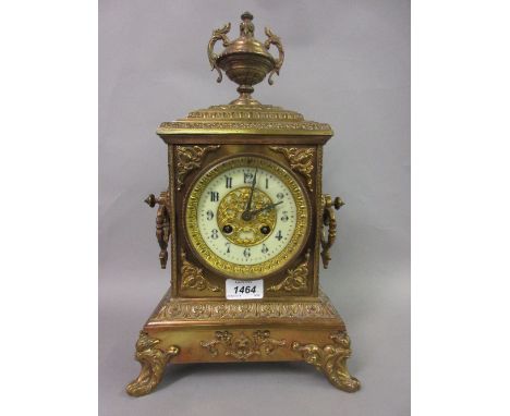 Late 19th Century gilt brass mantel clock of ornate design, the rectangular case with an urn surmount and shaped side handles