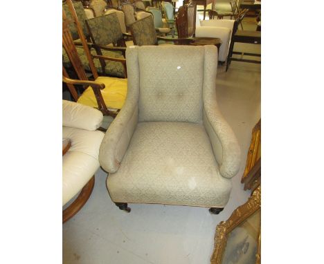 Late 19th / early 20th Century library armchair on turned tapering supports with brass caps and ceramic casters