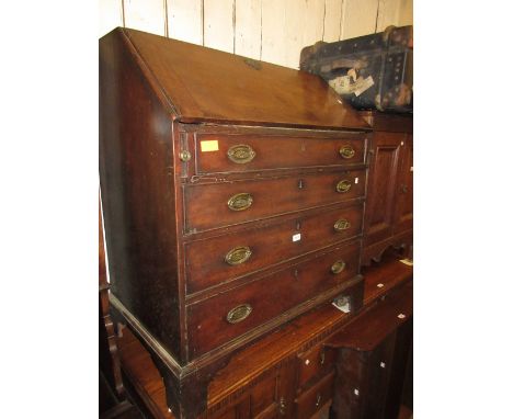 George III mahogany bureau with a fall front enclosing a fitted interior over four graduated drawers with oval brass handles 