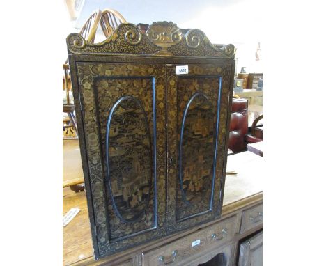 19th Century Chinese export lacquer table cabinet, the shaped shell and scroll cornice above a pair of oval panelled doors de