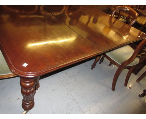 Victorian mahogany rectangular pull-out extending dining table, the moulded top with one large and one smaller extra leaf rai