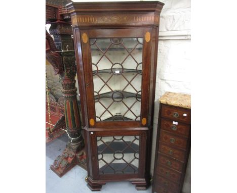 George III mahogany and marquetry inlaid standing corner cabinet, the moulded cornice above an inlaid frieze, the two bar gla