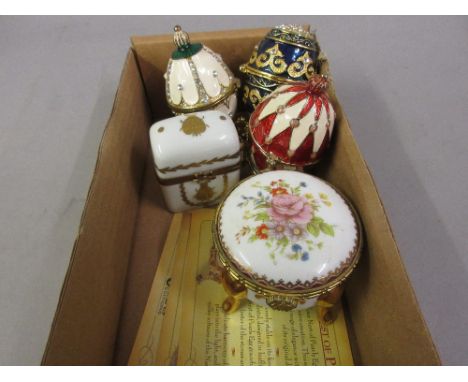 Three modern gilt metal enamelled egg trinket boxes, together with a French porcelain box containing two scent bottles and a 