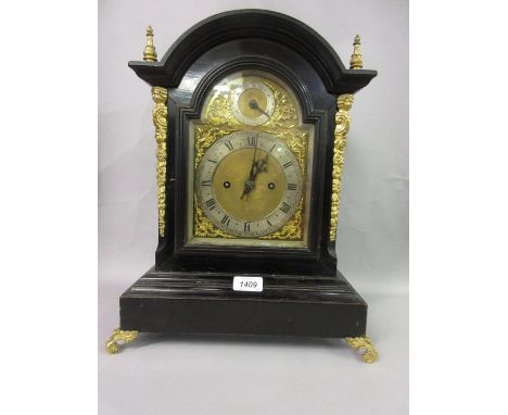 19th Century ebonised ormolu mounted arched top bracket clock, the gilded and enamel dial with Roman and Arabic numerals and 