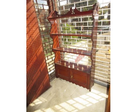 Late Victorian mahogany four shelf open wall bracket with two panel doors to the base